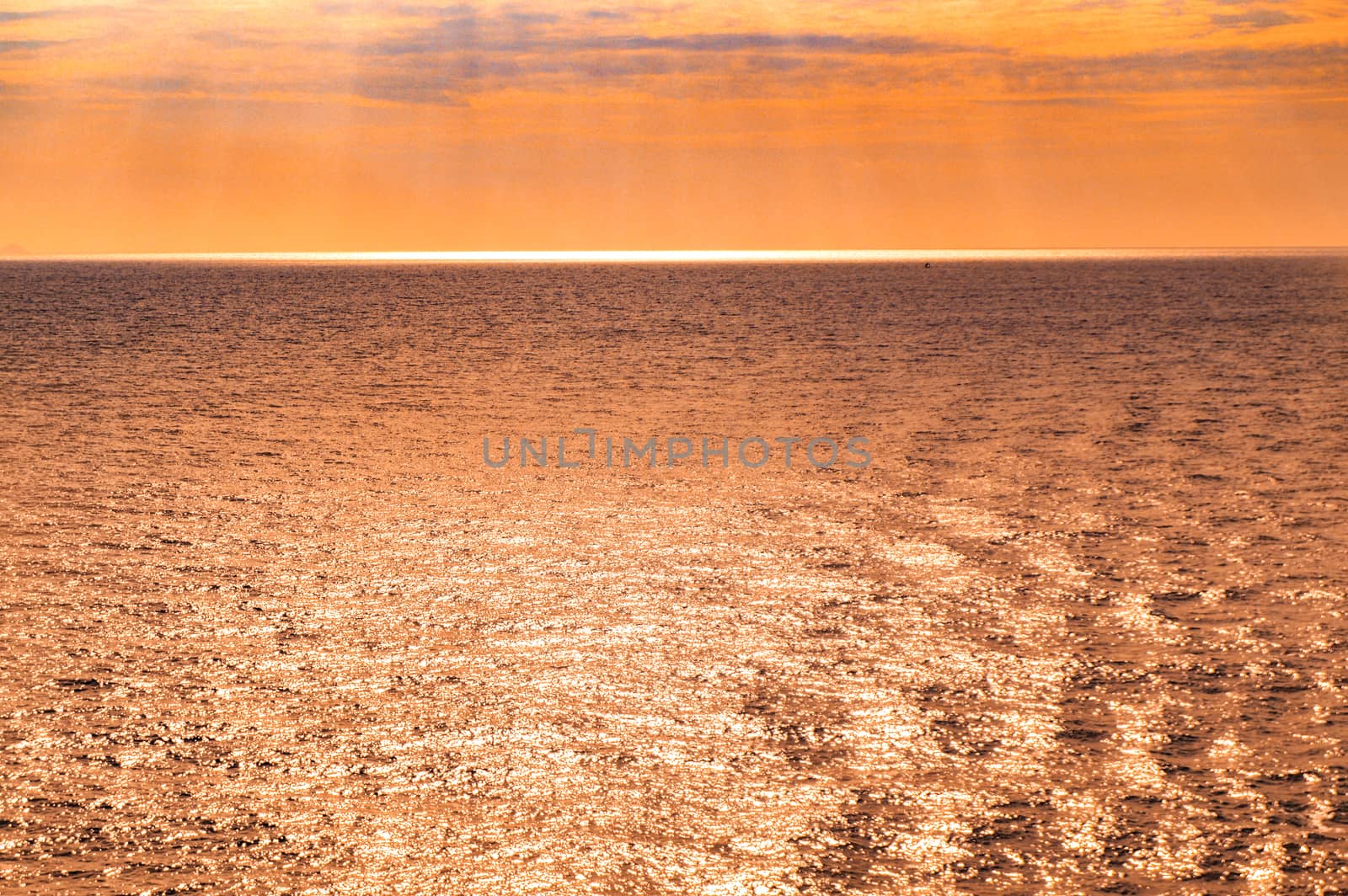 Orange sunset over the sea, Glare of sunlight on the surface of sea water, magical Golden and silver light, fantastic natural sunsets by claire_lucia