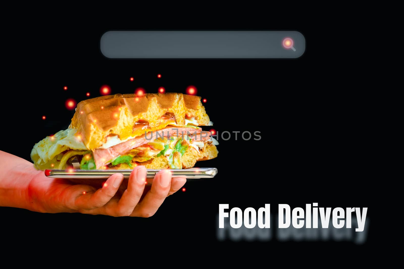 Waffles sandwiched floating from a smartphone in hand holding with the search box and food delivery word on a black background. New normal and food online concept.