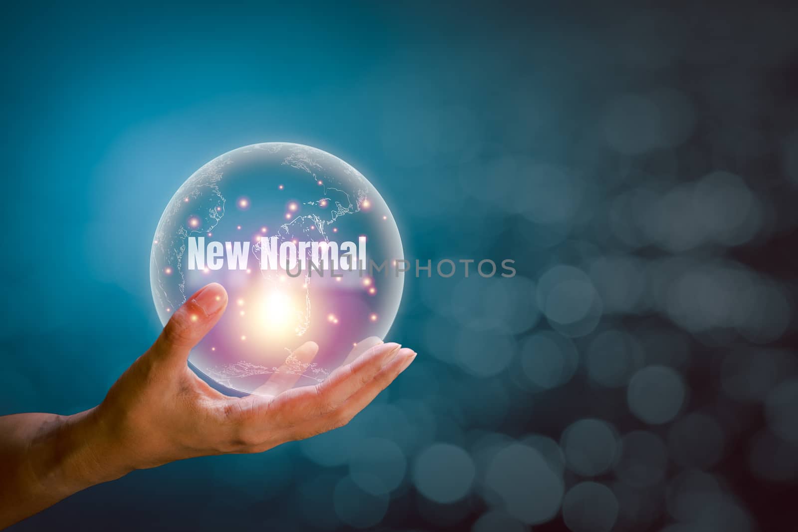 Transparent of earth with the word of new normal floating above the hand with orange and blue light on a white bokeh background and copy space. New normal concept.