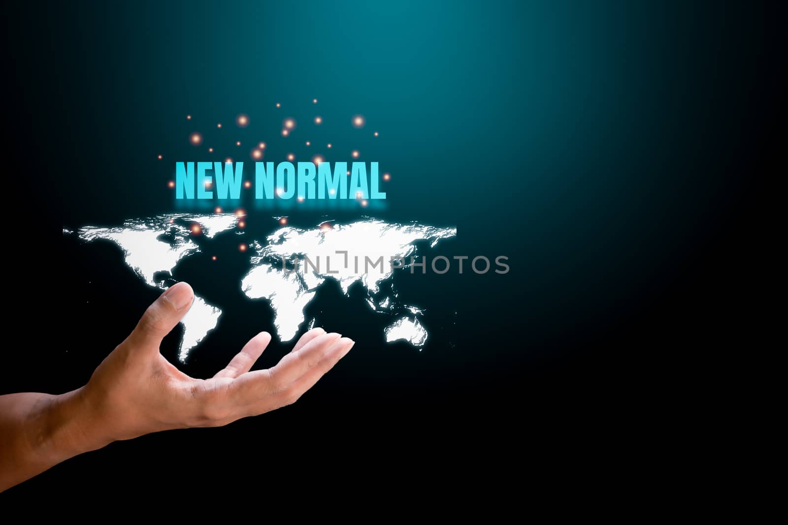 Hand holding white world map with blue text 'new normal' and orange light on blue and black technology background. New normal concept.