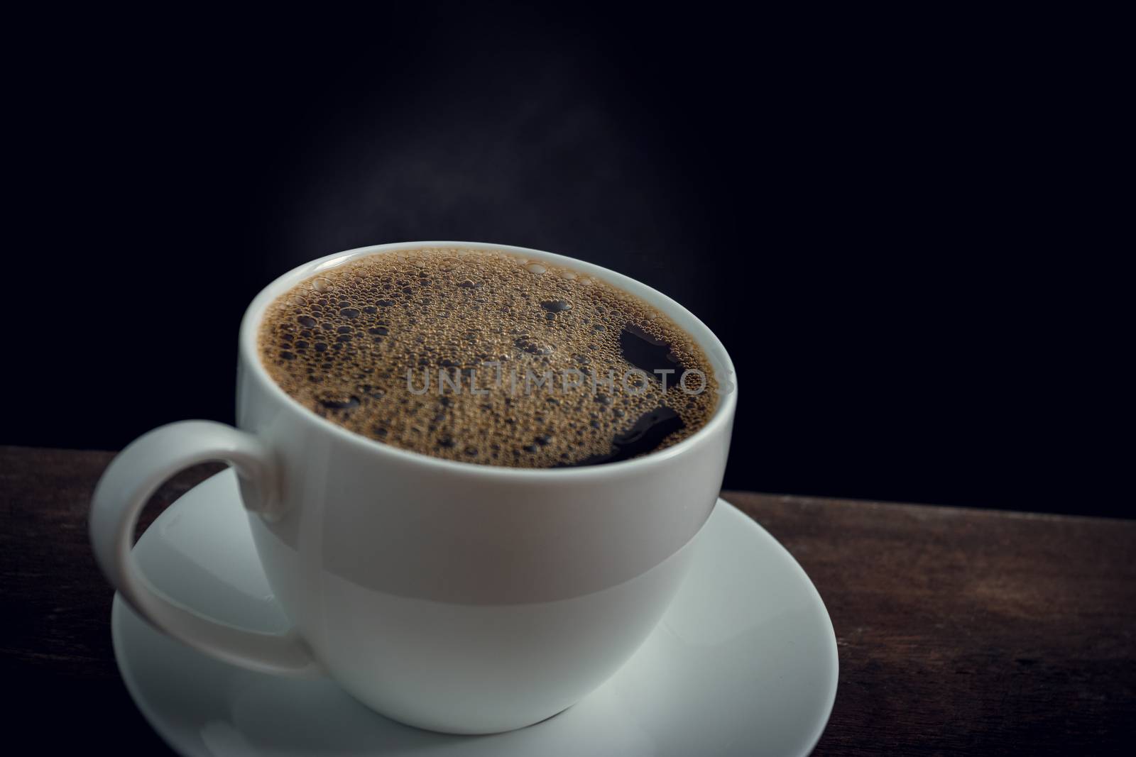 Cup of coffee on old wooden table