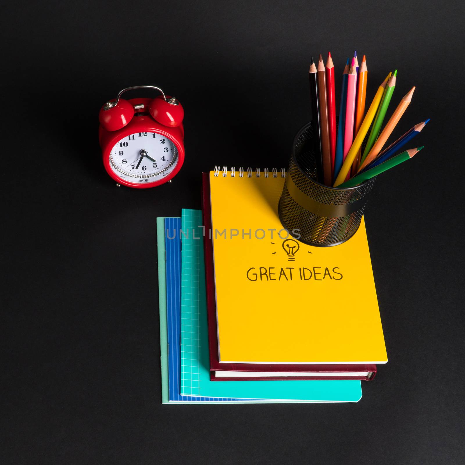 colorful collection of school supplies set on black background. back to school. top view