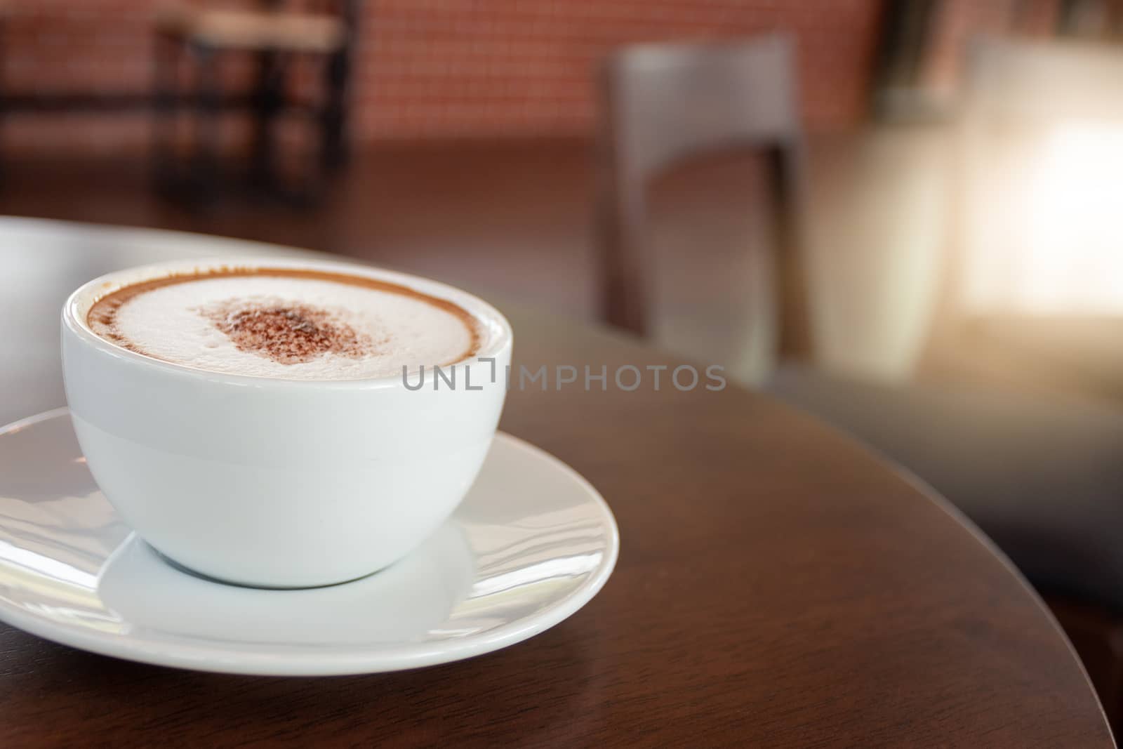 Coffee cup of cappuccino in cafe in an empty cafe without people.
