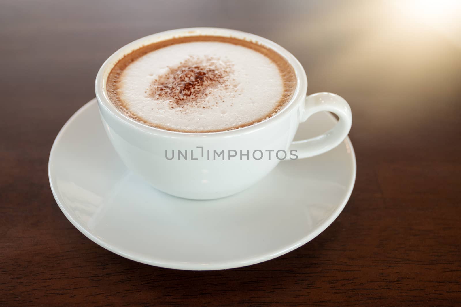 Coffee cup of cappuccino on wooden table in cafe 