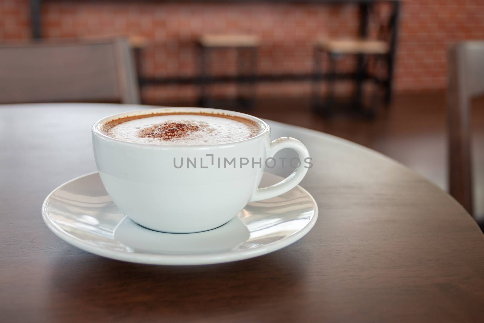 Coffee cup of cappuccino in cafe in an empty cafe without people.