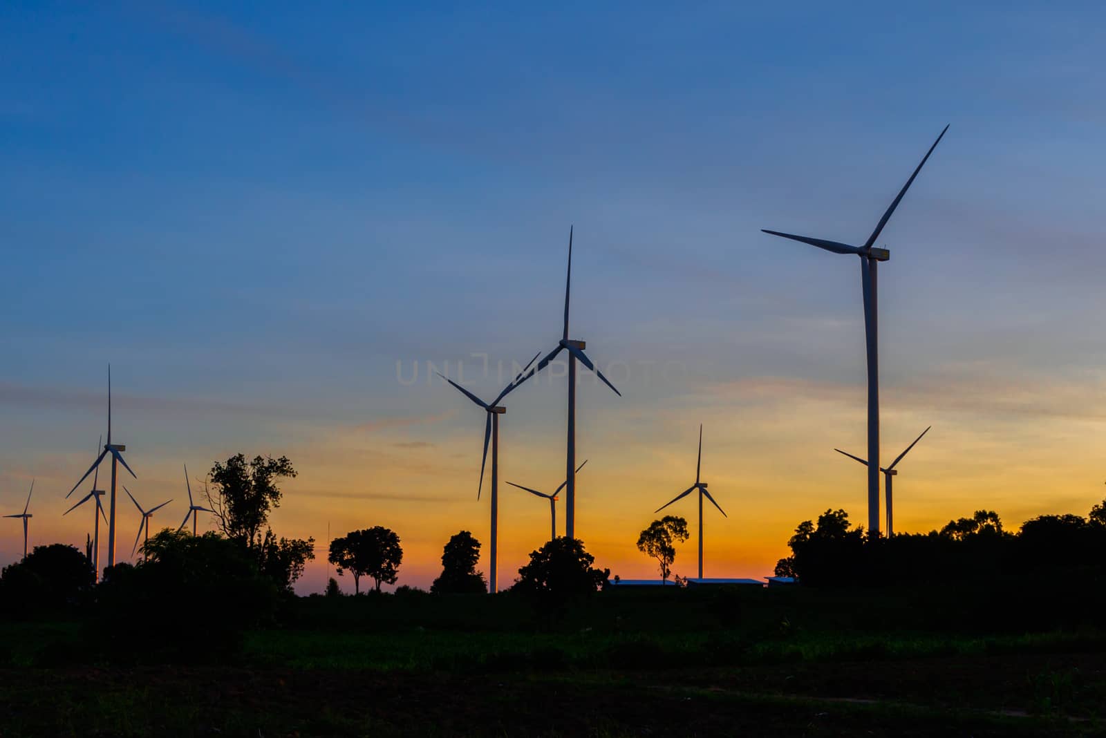 Wind turbines silhouette at sunset by joeasy