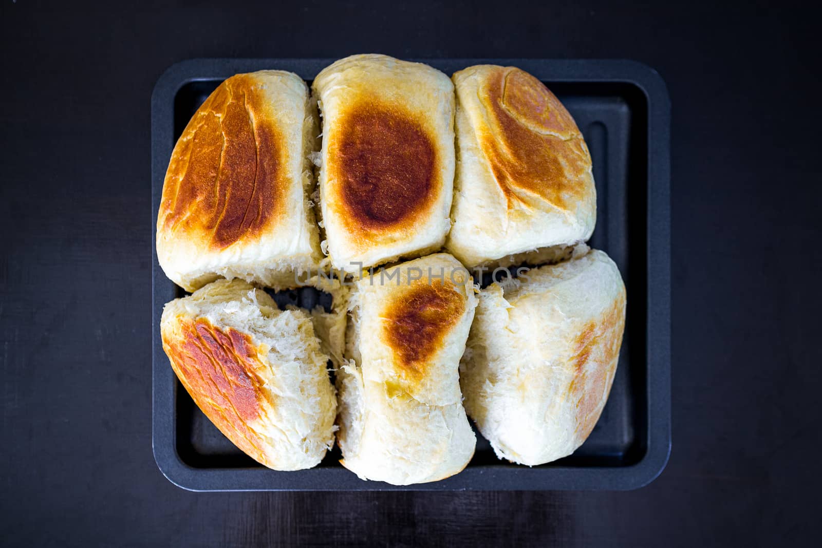 Bread freshly baked in tray from oven.