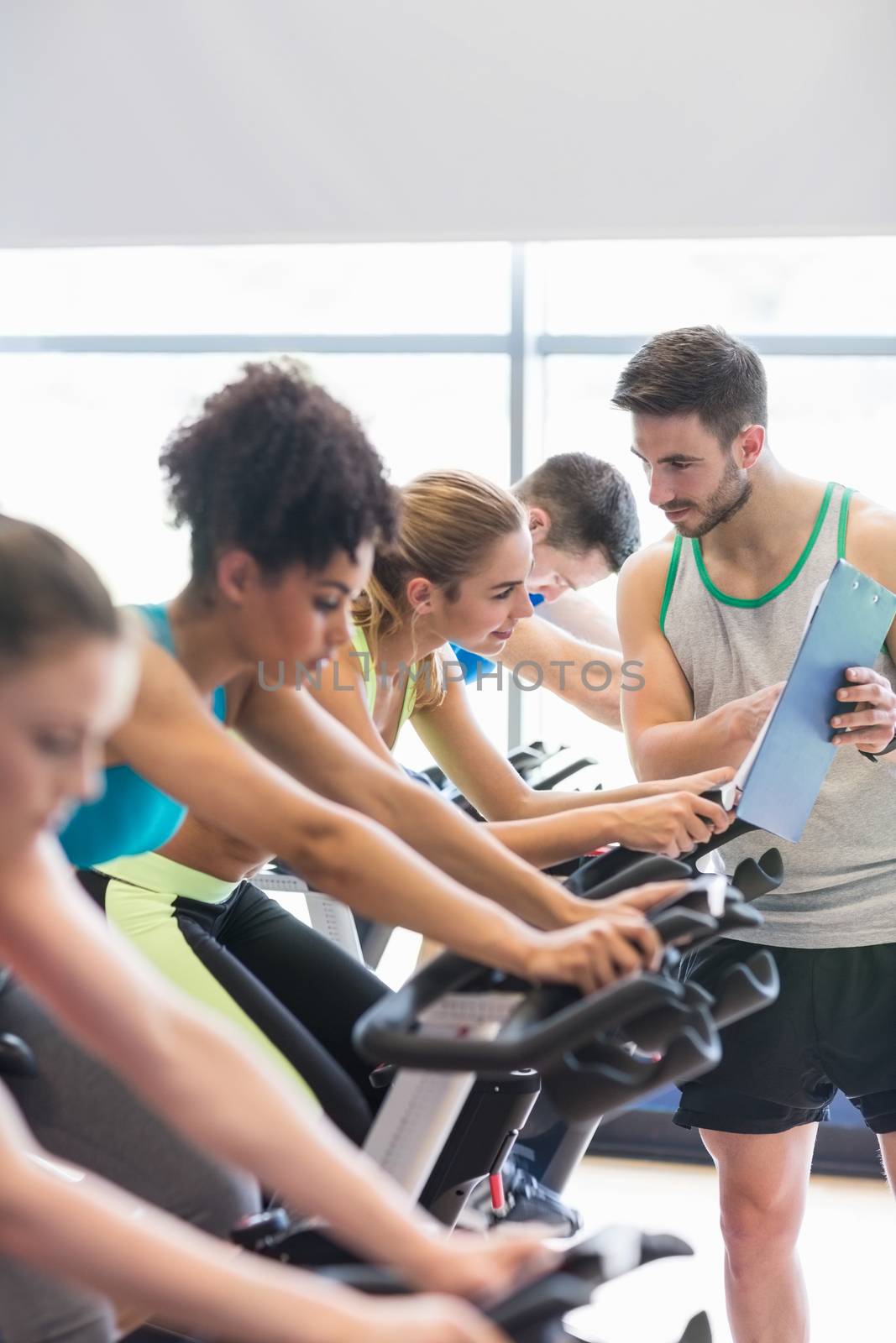 Fit people in a spin class at the gym