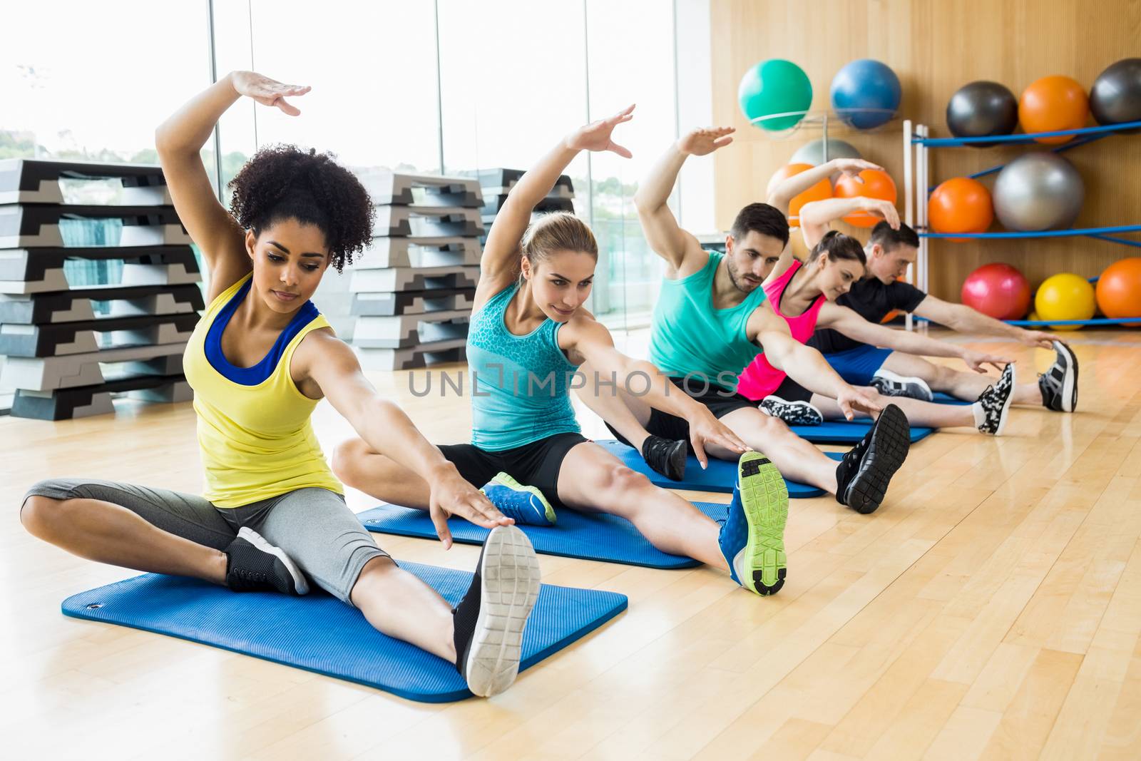 Fitness class exercising in the studio at the gym