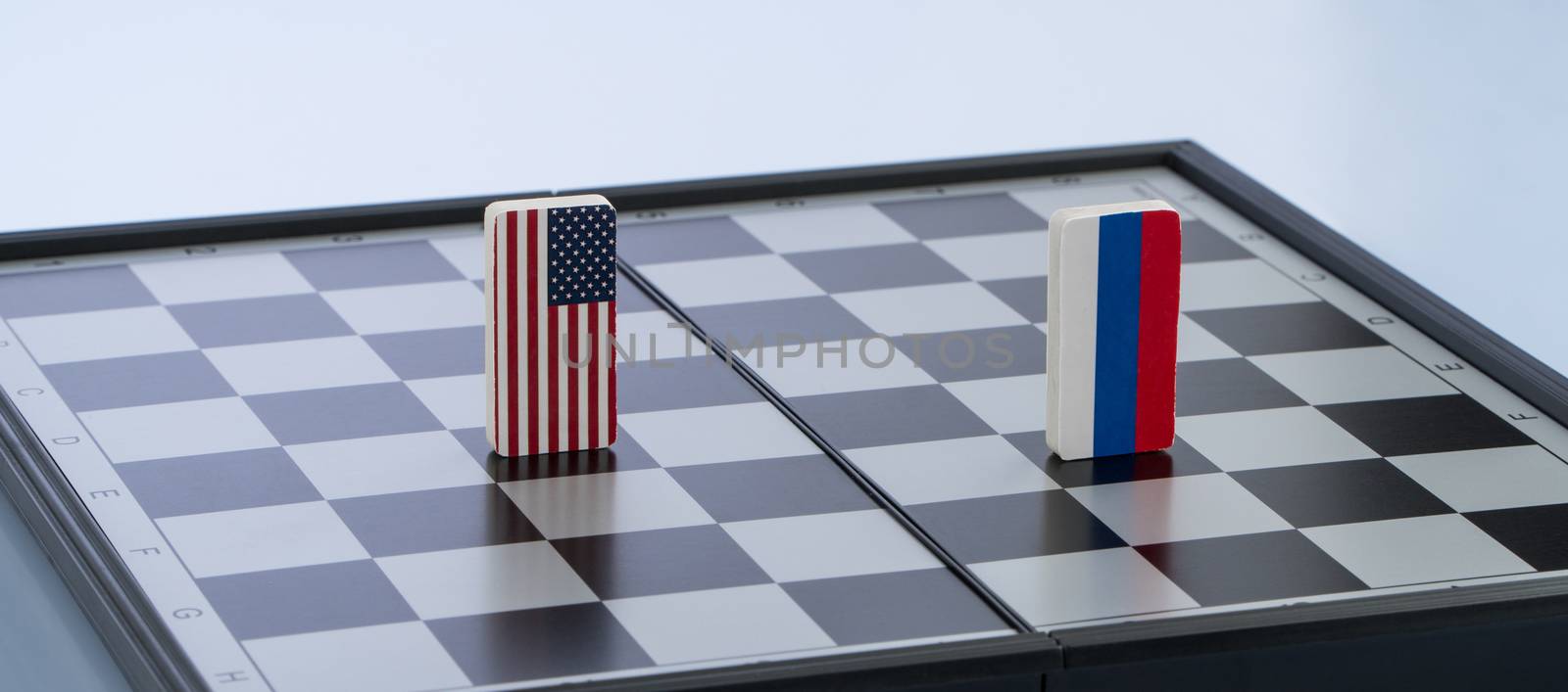 Symbols flag of Russia and the United States on the chessboard. The concept of political game.
