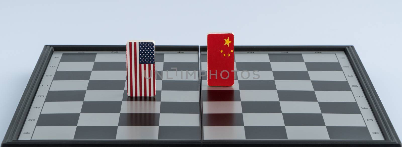 Symbols of the flag of the USA and China on the chessboard. The concept of political game.