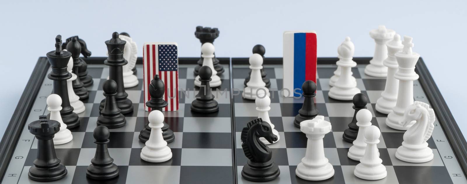 Symbols flag of Russia and the United States on the chessboard. The concept of political game.