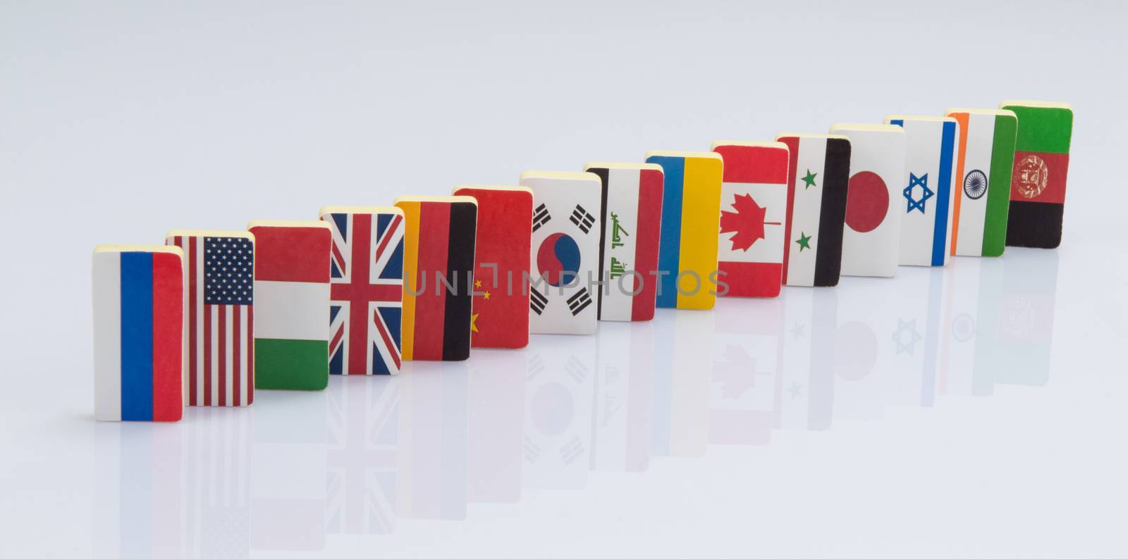 The domino effect with tiles of flags of different countries of the world. conceptual photo, political games. Studio shooting