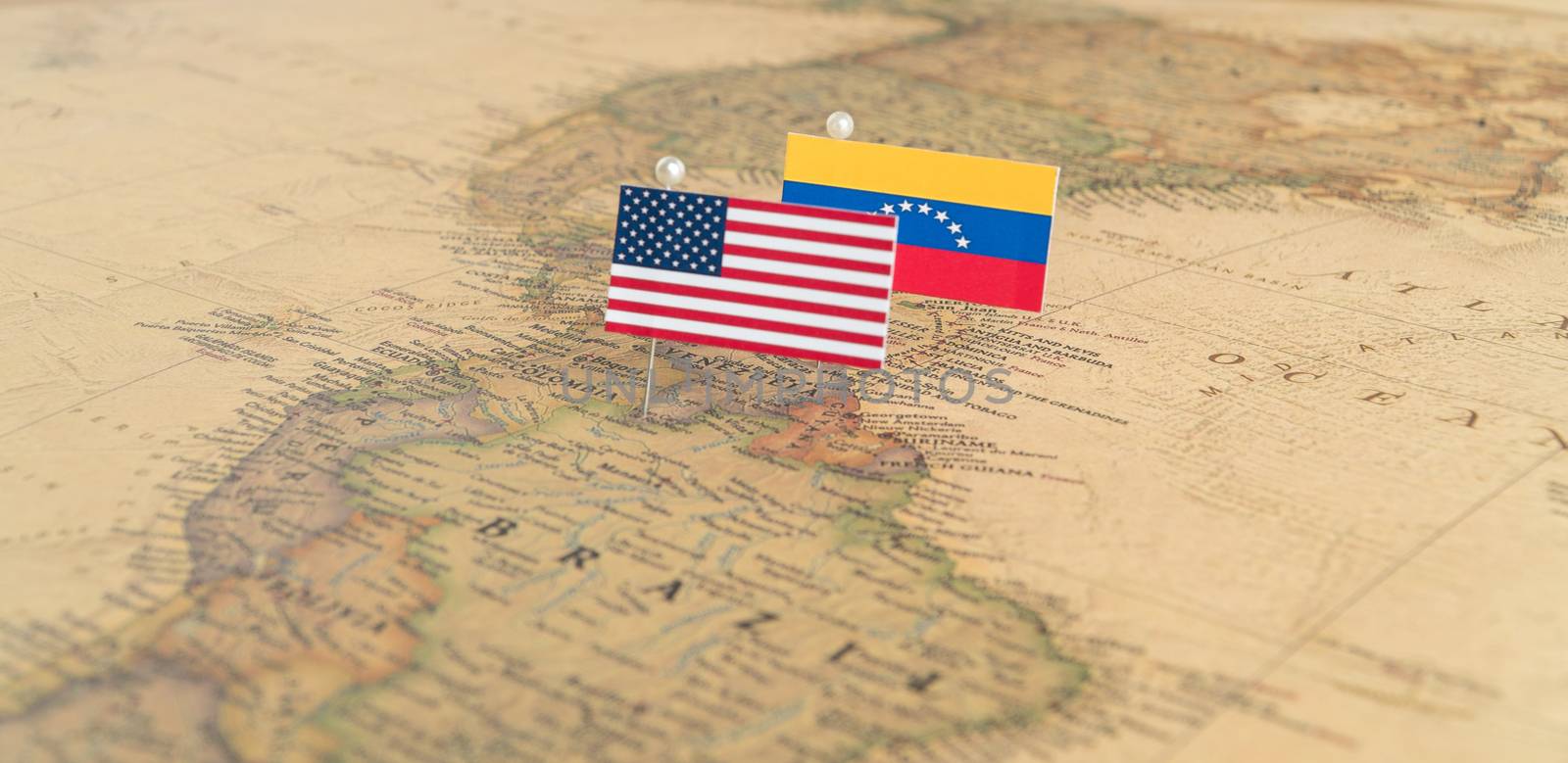 Flags of the USA and Venezuela on the world map. Conceptual photo, politics and world order