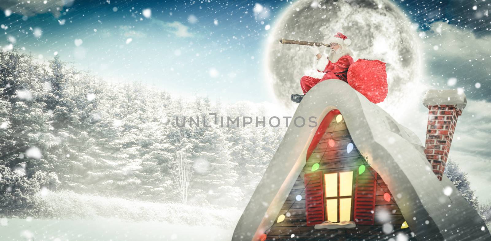 Santa sitting on roof of cottage against snow covered trees against sky