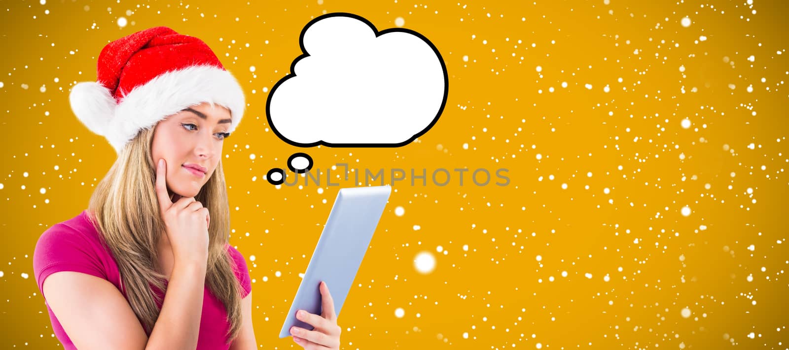 Festive blonde looking at tablet pc against yellow background with vignette