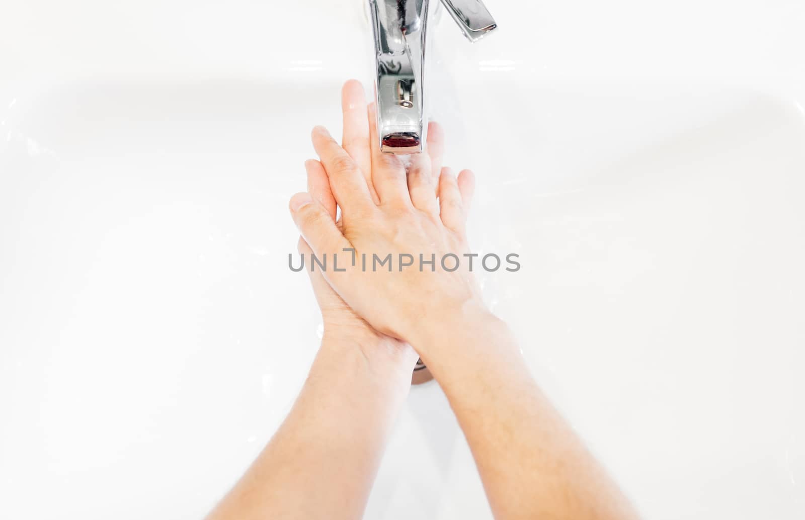 Man washing his hands hygienically with soap