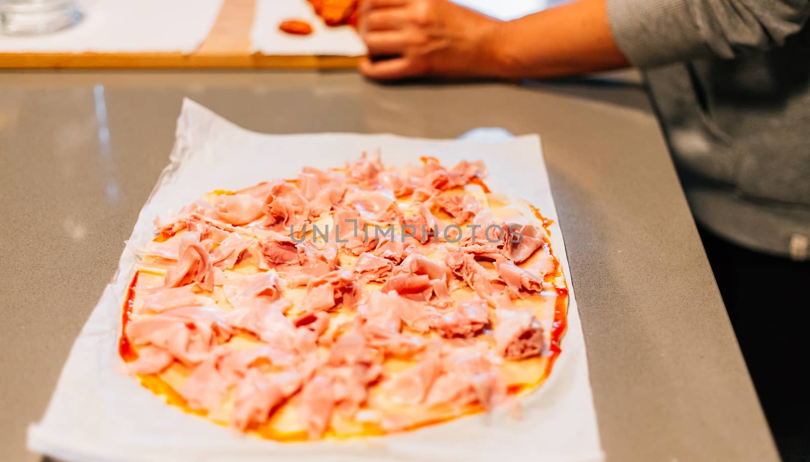 one person making a pizza