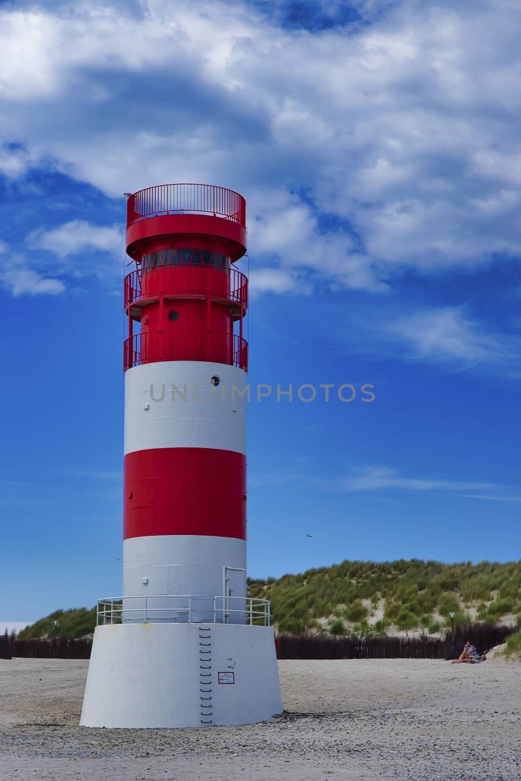 The red and white small Lighthouse on Island Dune - Heligoland - Germany with blue Sky