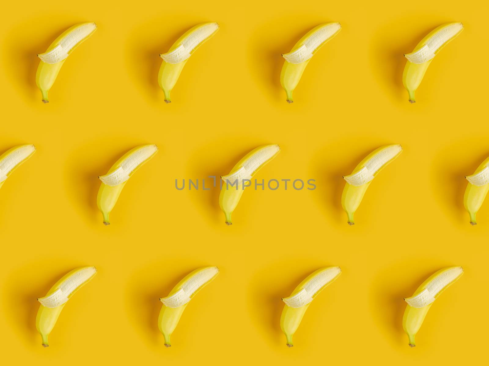 Tropical abstract background. Juicy ripe banana pattern on yellow background top. Seamless pattern with bananas.	