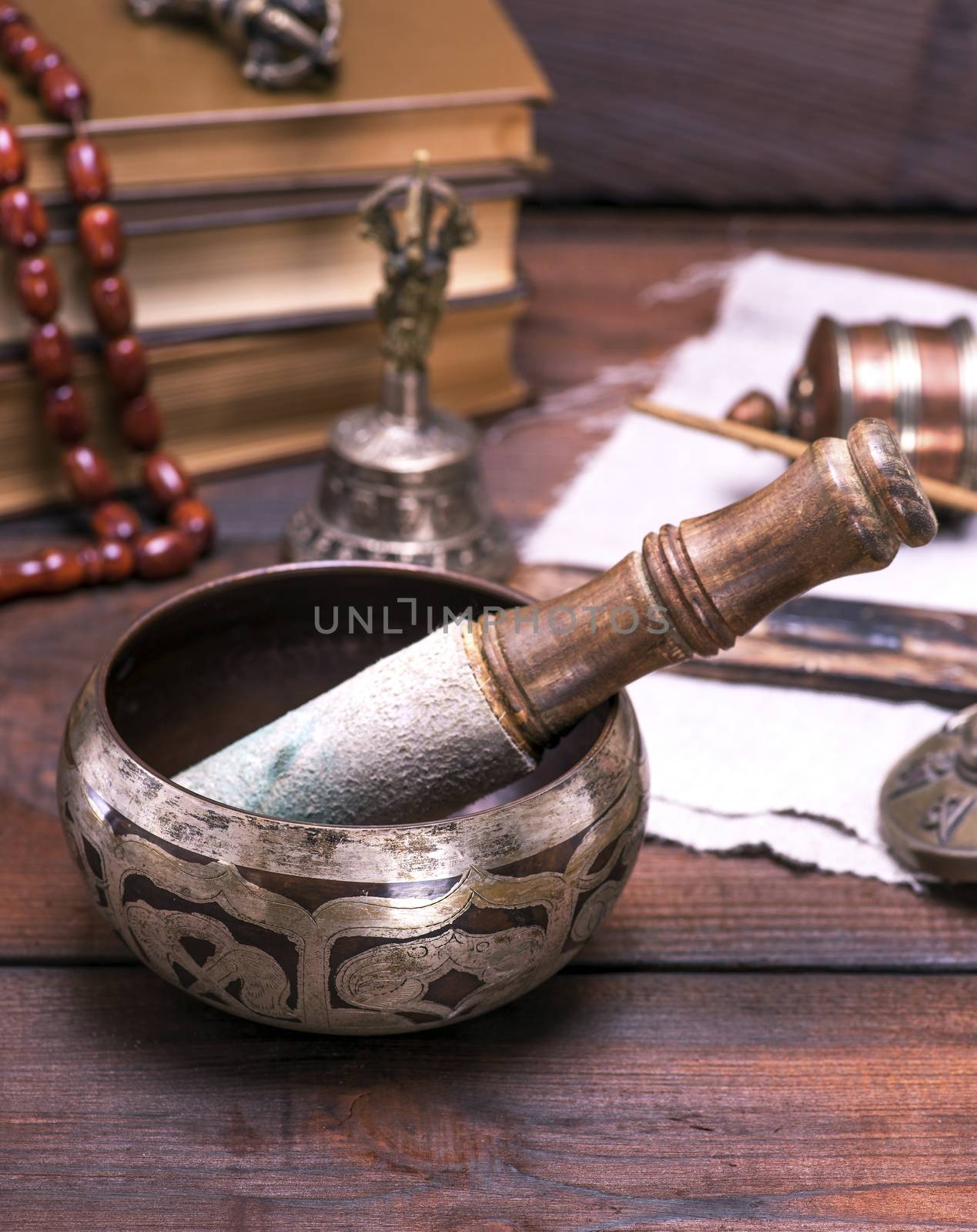  copper singing bowl and a wooden sticks by ndanko