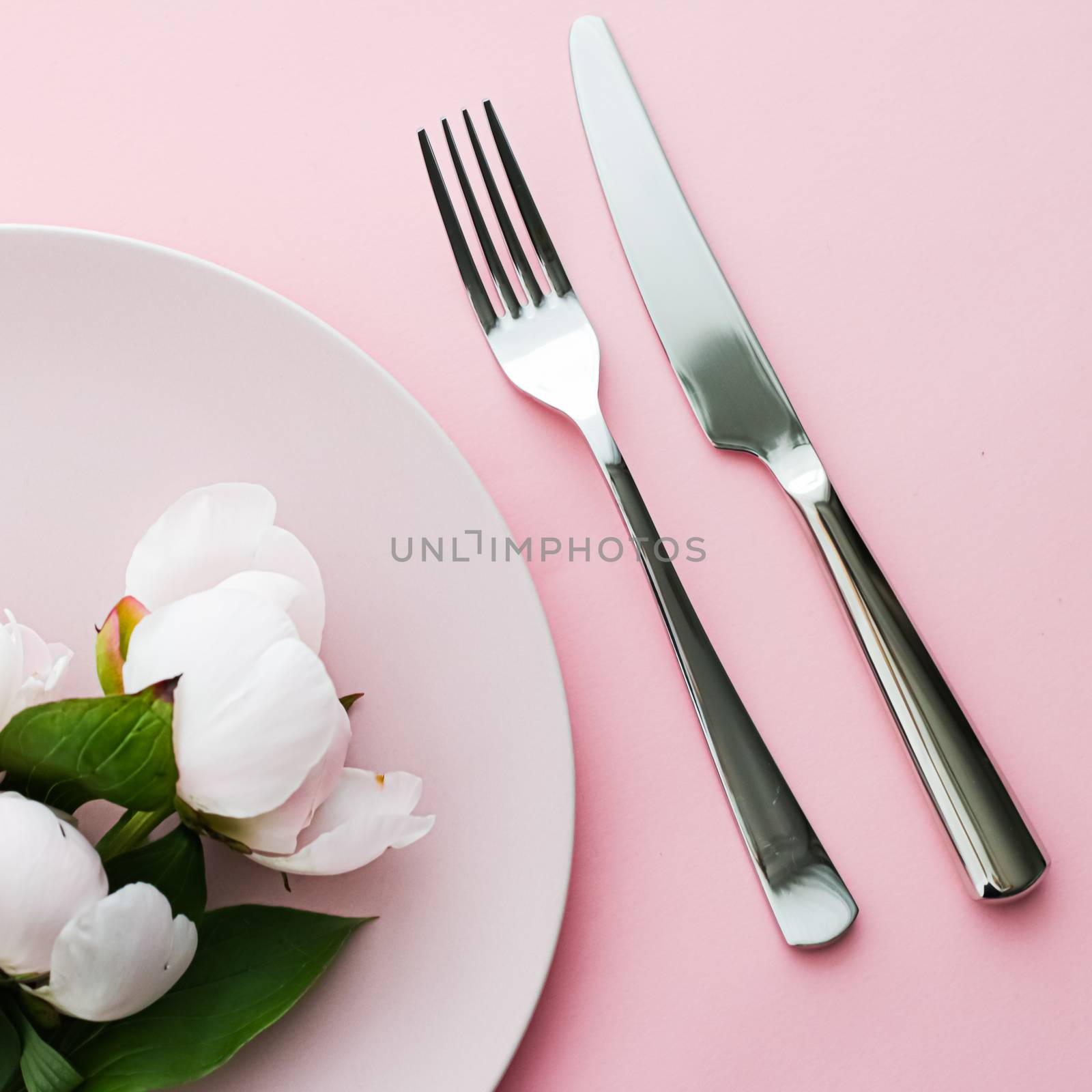 Dining plate and cutlery with peony flowers as wedding decor set on pink background, top tableware for event decoration and menu branding design