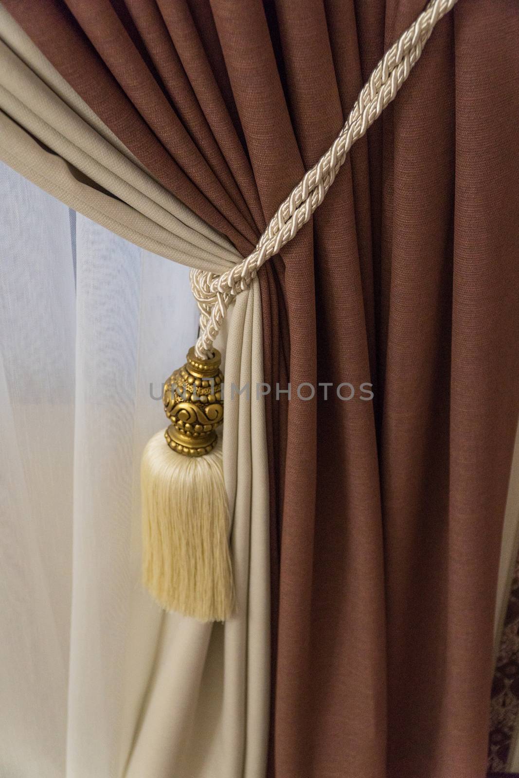 fragment of luxurious curtains with fringe and tassel