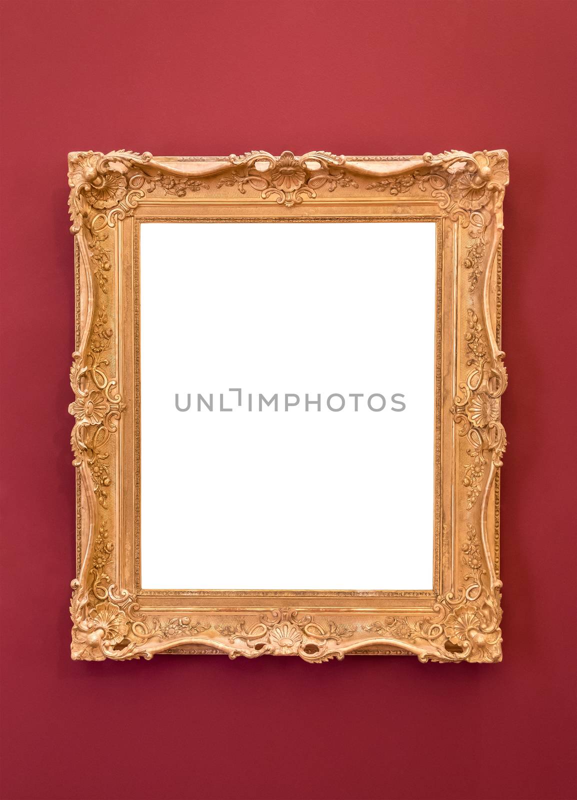 Empty golden picture frame on the red wall