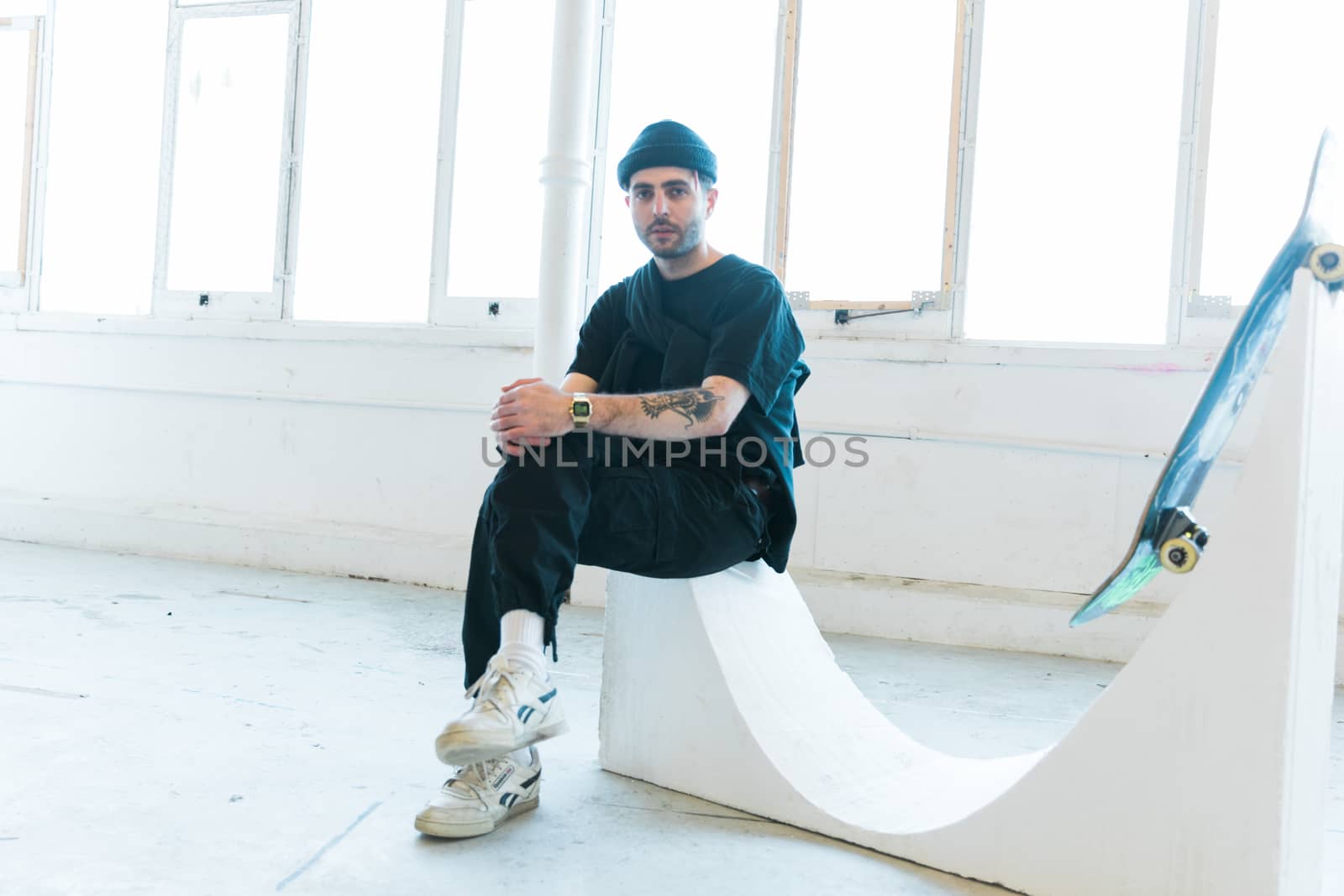 Portrait of relaxed young fashionable man in black outfit by camerarules