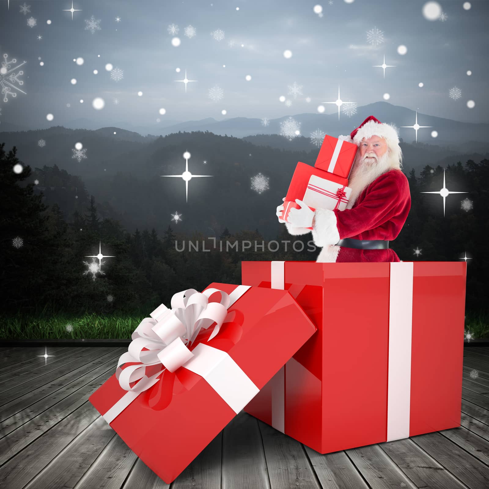 Santa standing in large gift against wooden planks against mountains