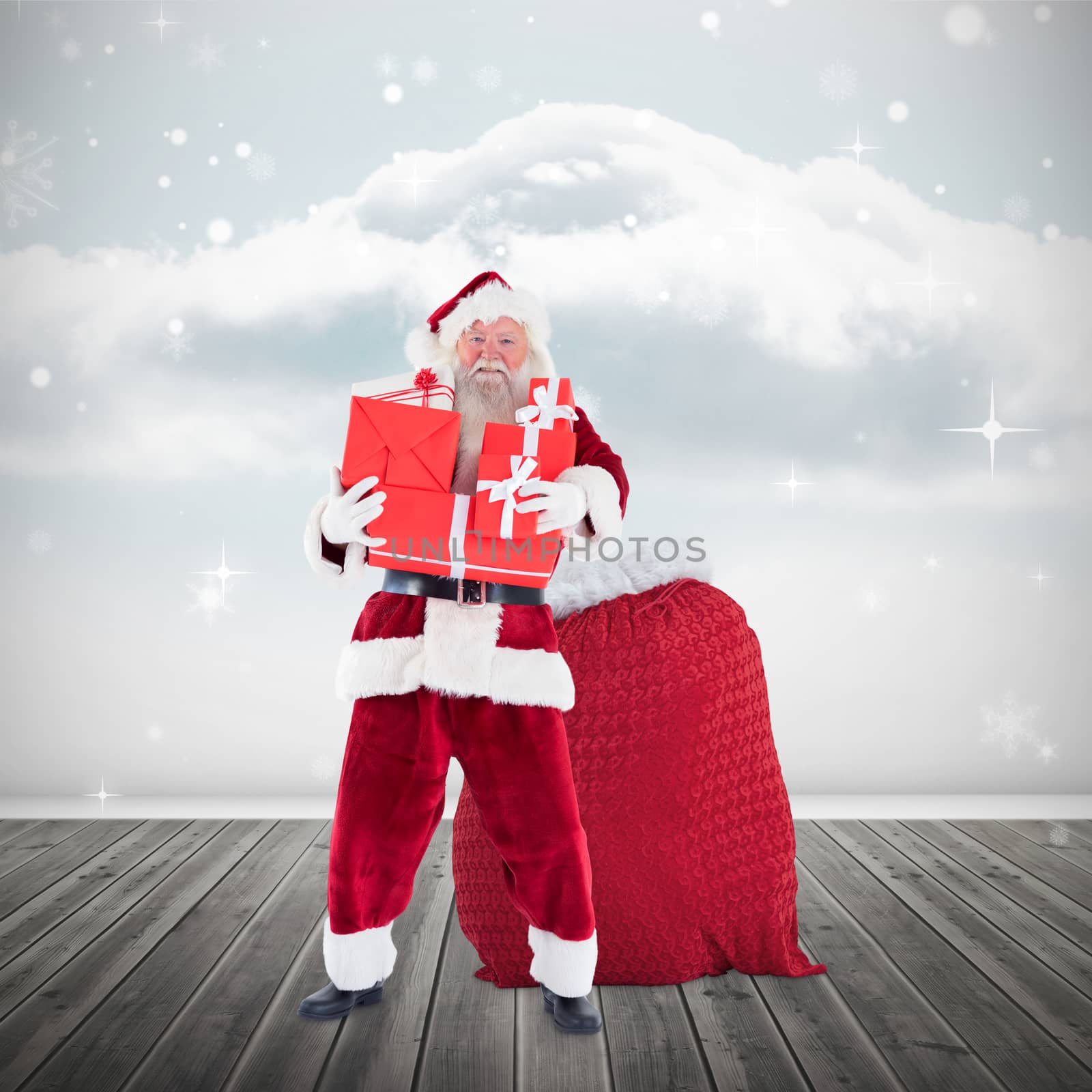 Composite image of santa holding pile of gifts by Wavebreakmedia