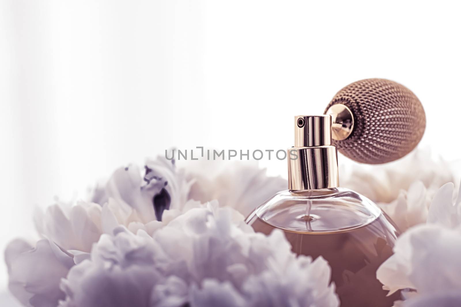 Luxe fragrance bottle as vintage perfume product on violet background and peony flowers, parfum ad and beauty branding design