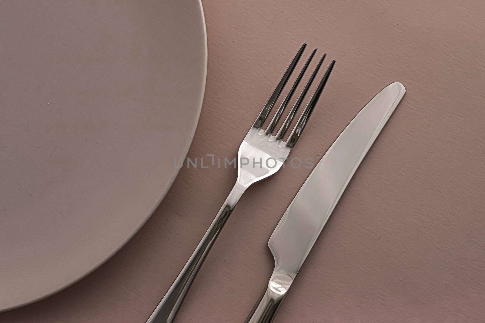 Empty plate and cutlery as mockup set on brown background, top tableware for chef table decor and menu branding design