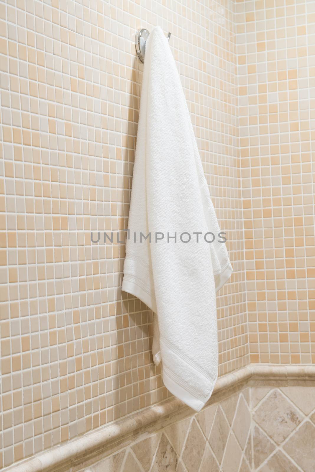 white terry towel hanging in the hotel bathroom