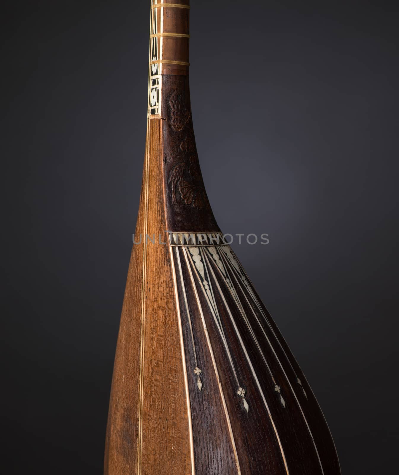 part ancient Asian stringed musical instrument on black background with backlight