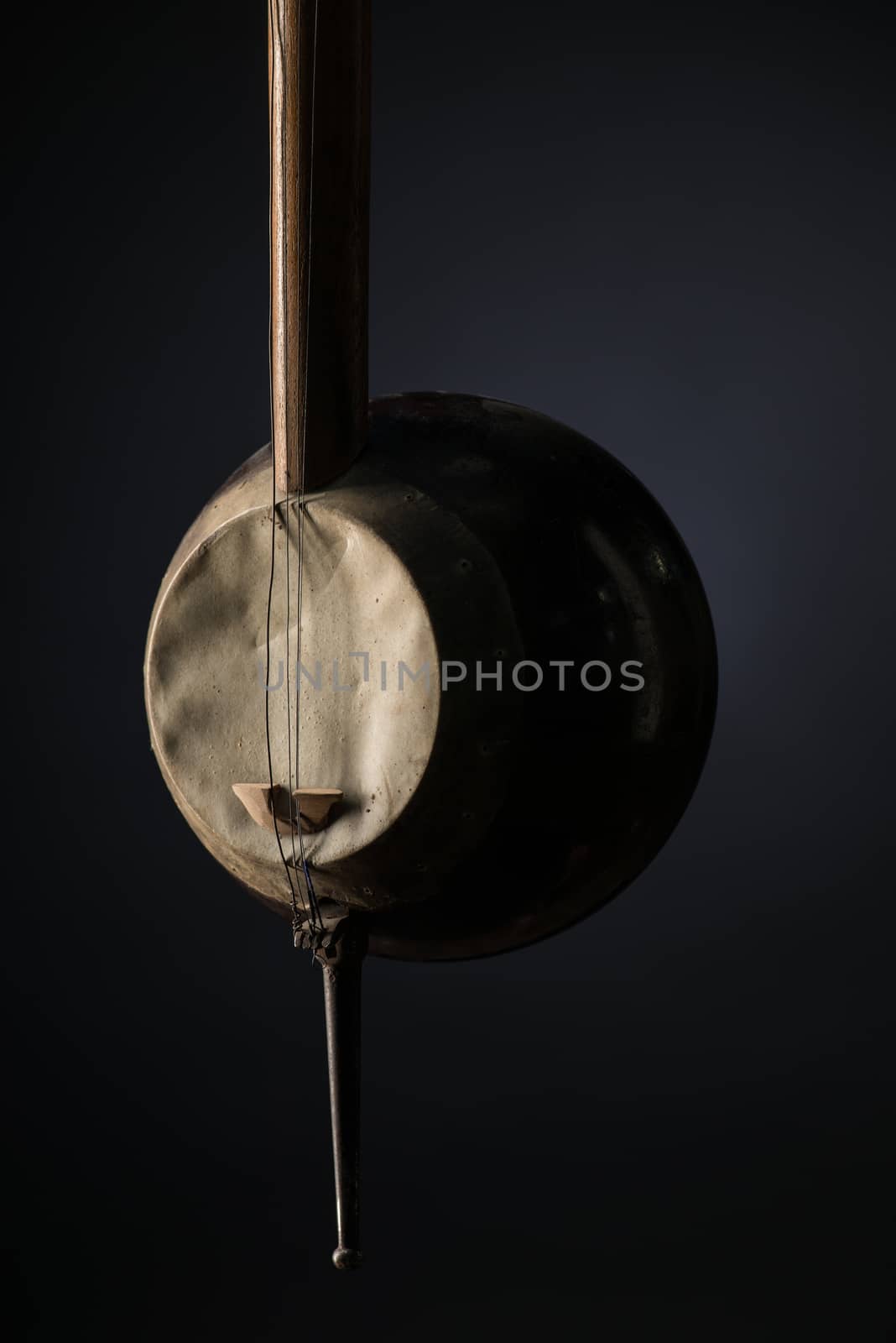 part ancient Asian stringed musical instrument on black background with backlight