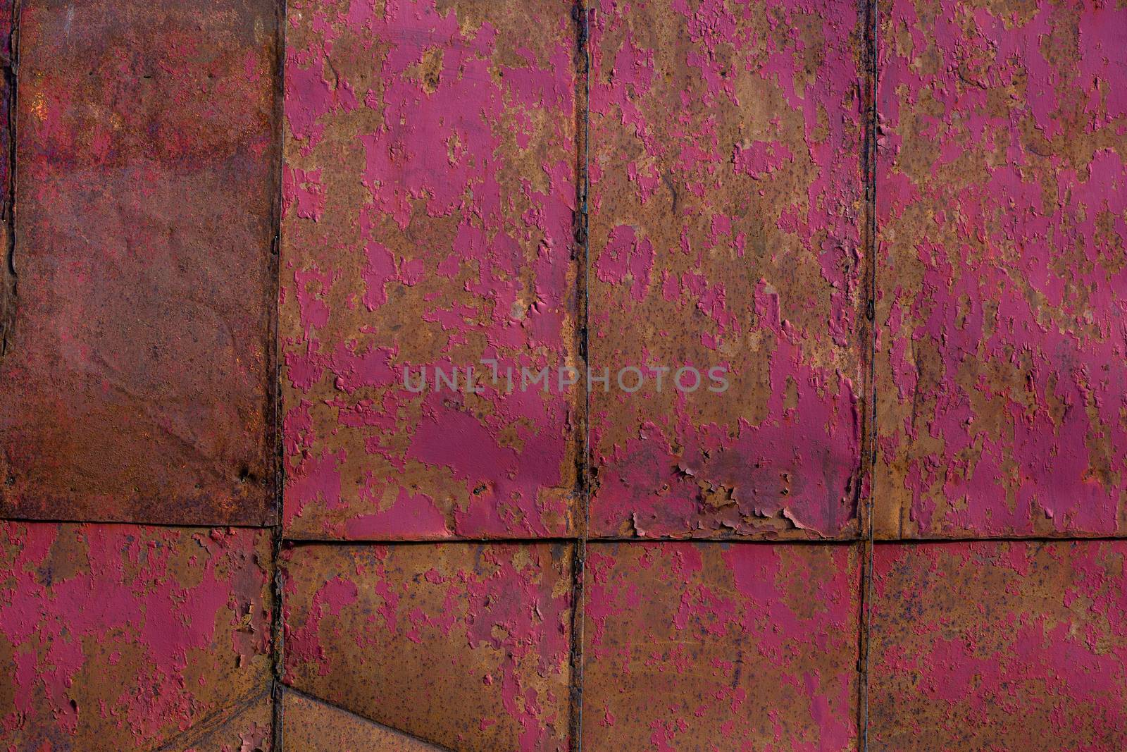 rusted tin sheets patchwork wall texture and flat background with peeling leftovers of old pink paint