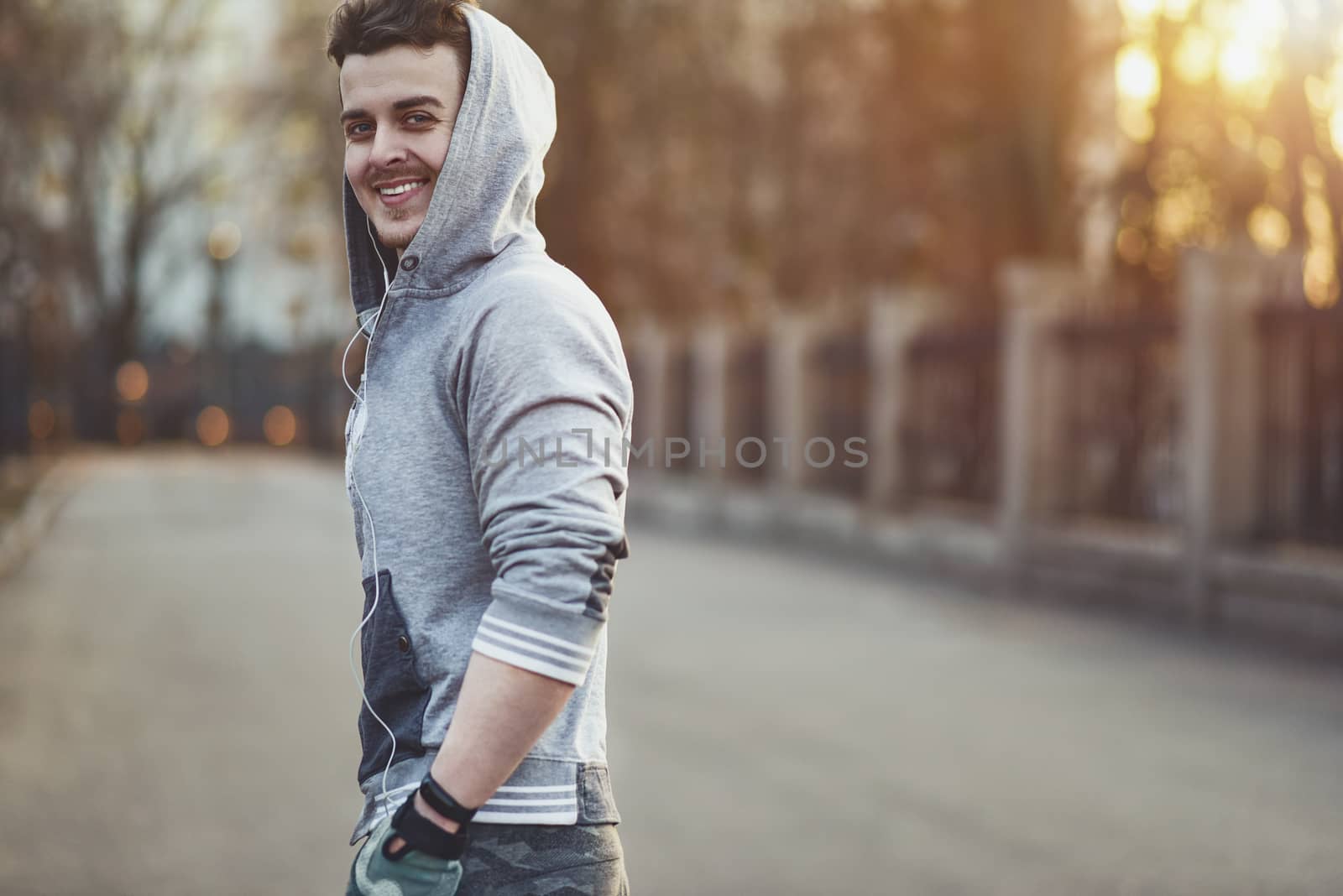 Sporty young man working out at early morning with background sunrise