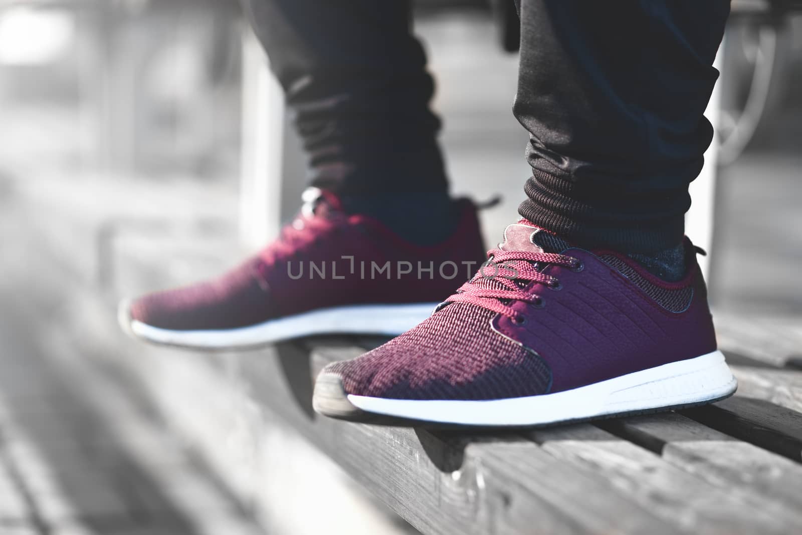 Man in sneakers walks down the street on a sunny day