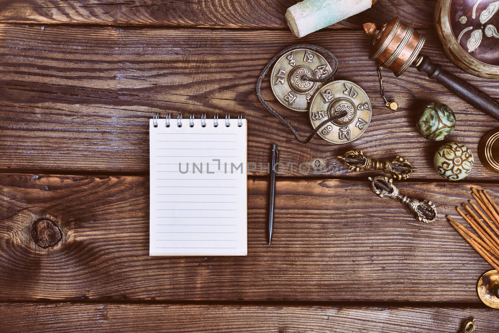 Empty paper notebook and Tibetan religious musical instruments by ndanko