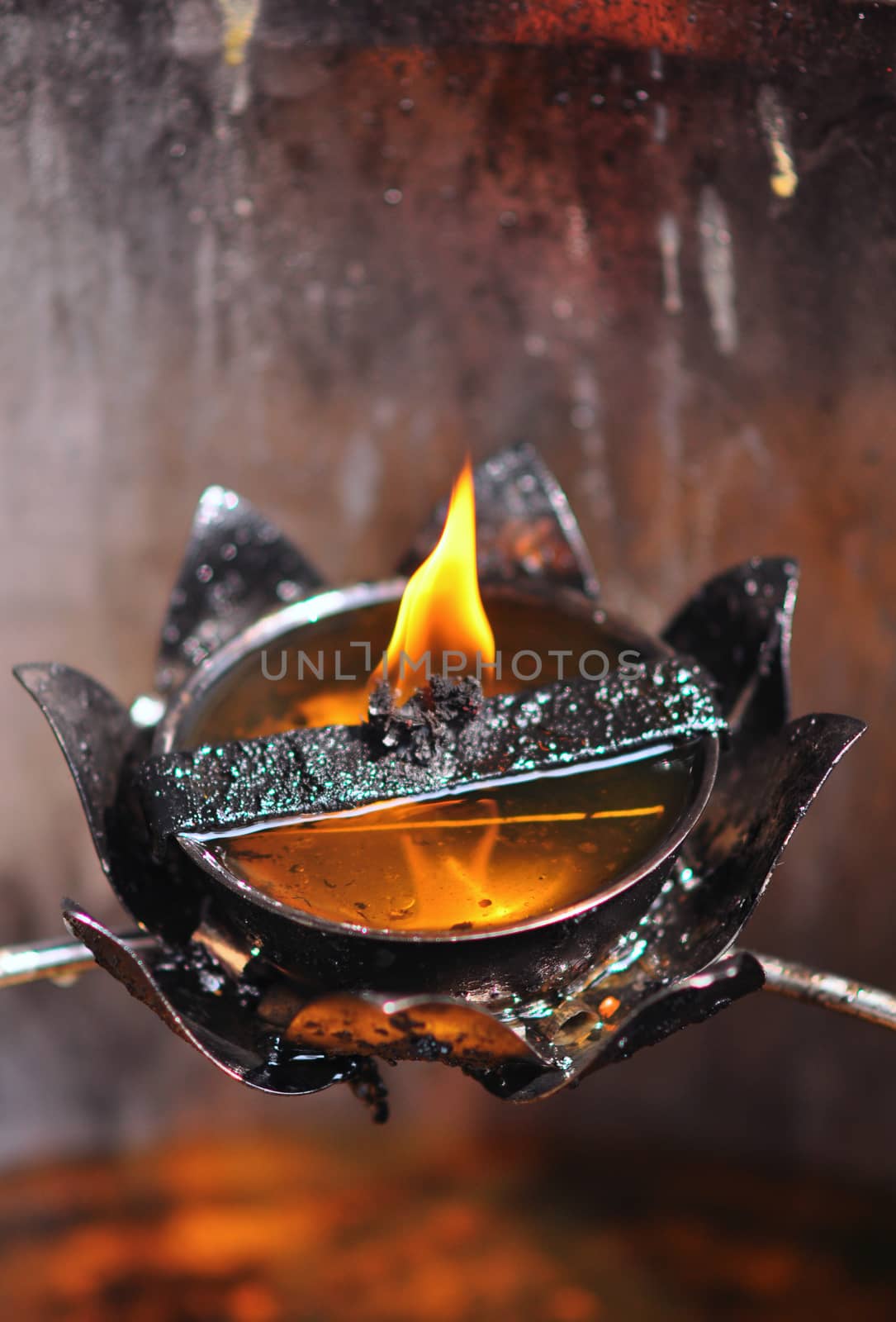 The flame of the oil lamp in the dark, Thai oil lamp.