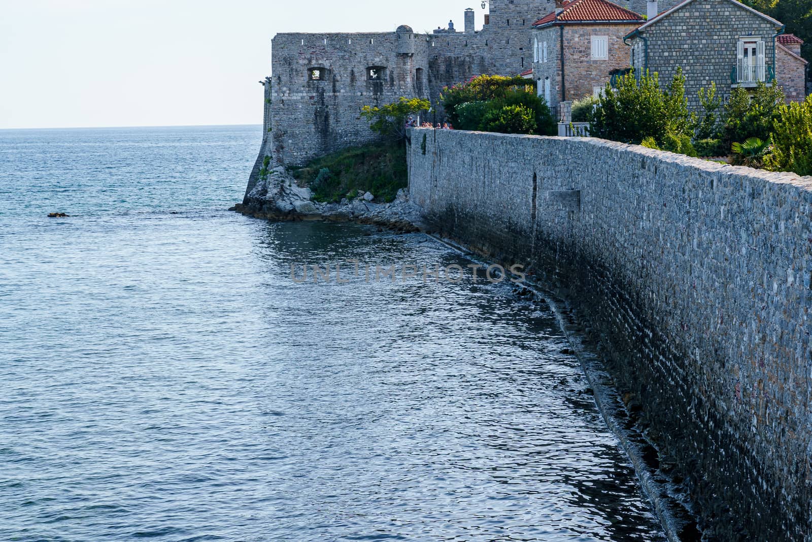 Fortress over the sea, stone wall, loopholes. Architectural monument in the city of Budva, in Montenegro.