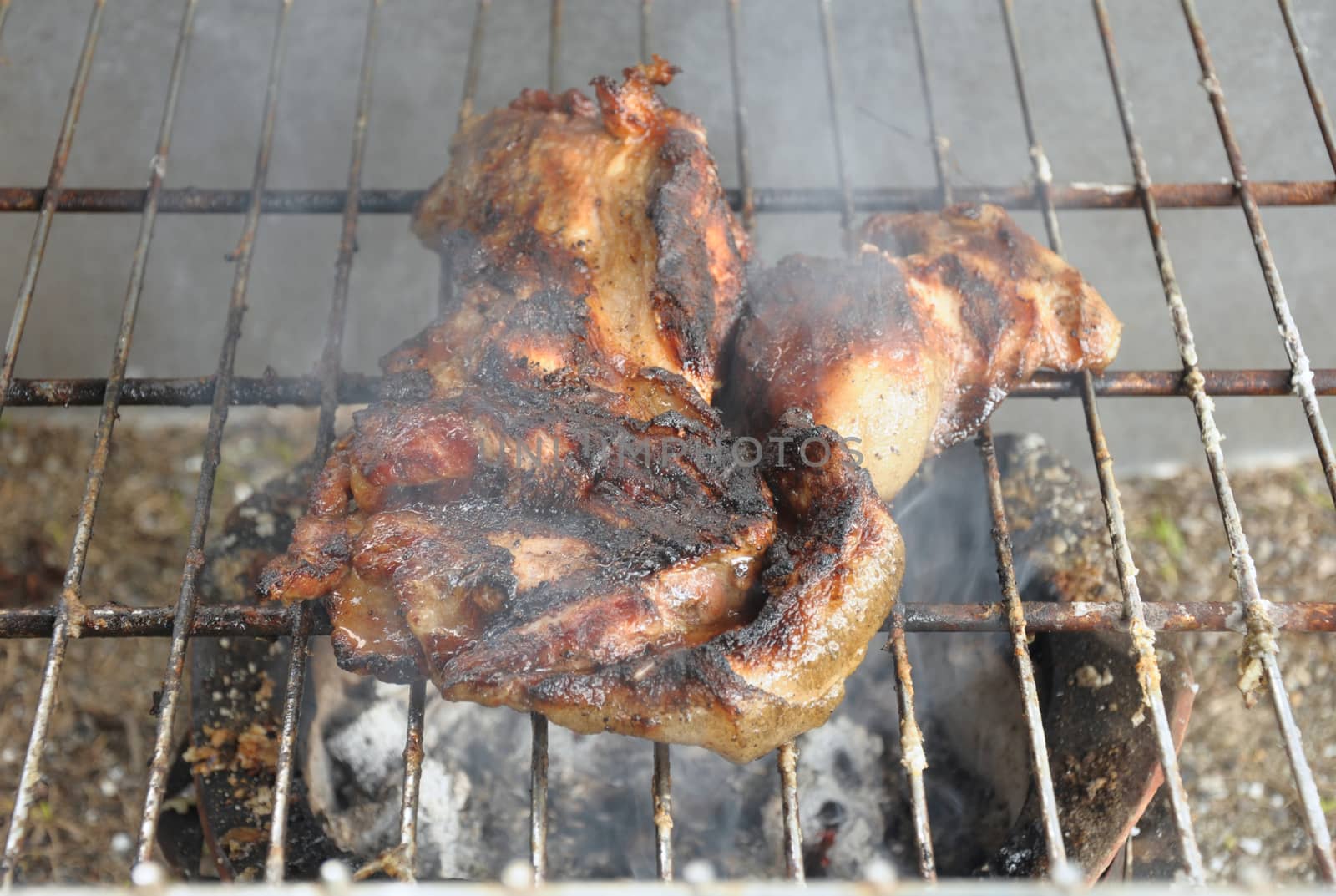 Pork roasted on a charcoal grill, grilled until cooked.