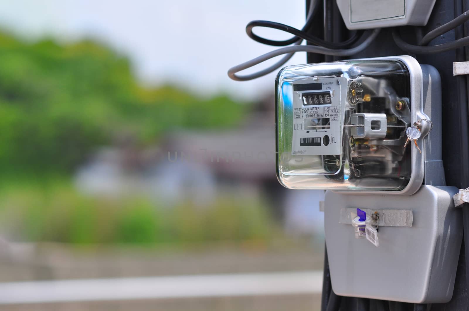 Electric power meter measuring power usage. Watt hour electric meter measurement tool at pole, 
outdoor electricity for use in home appliance monitor the home`s electrical energy consumption.