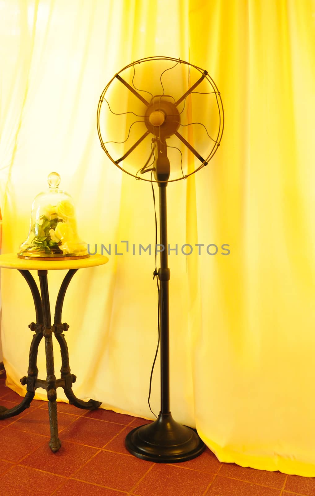 Black ancient Thai fans There is a yellow curtain in the background.