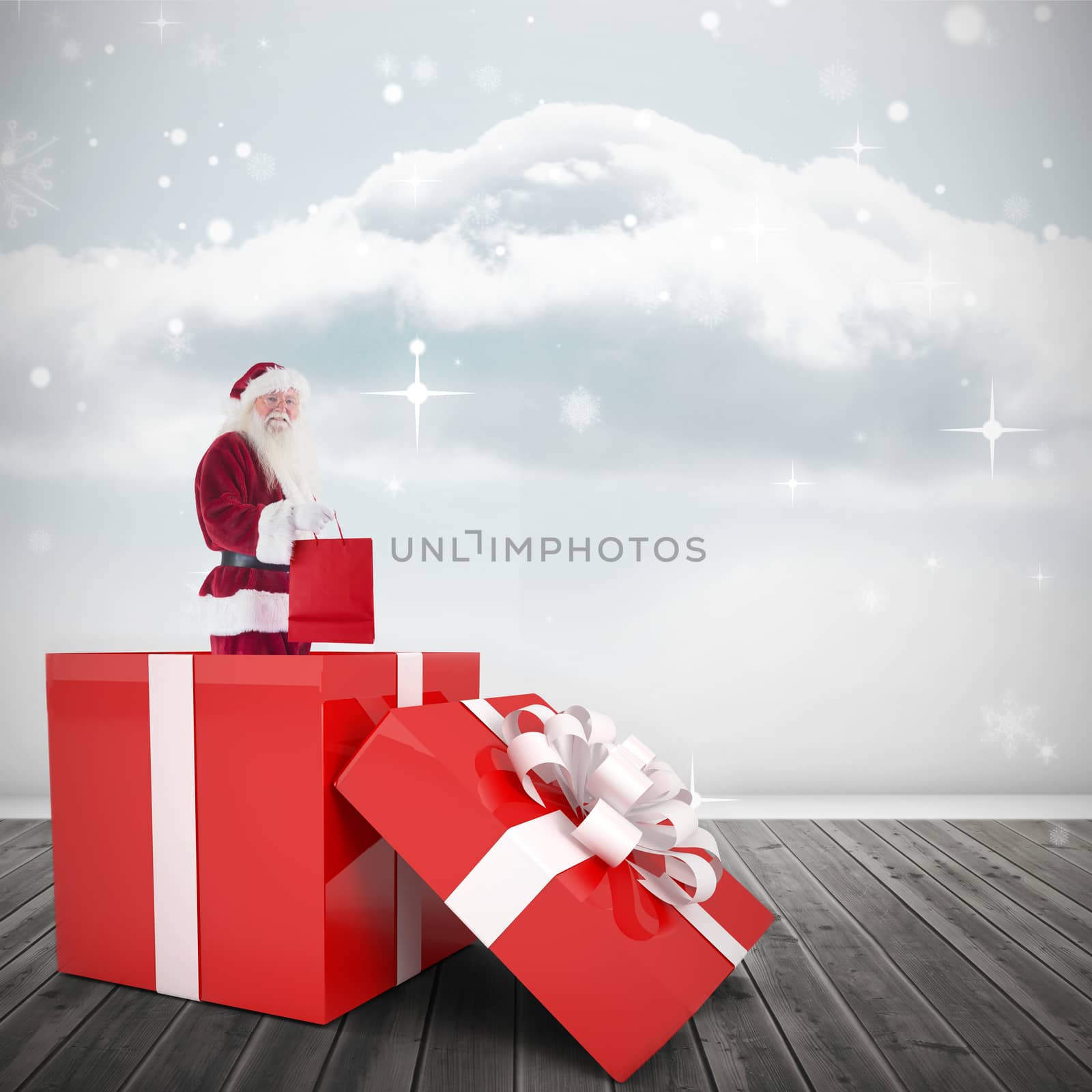 Composite image of santa standing in large gift by Wavebreakmedia