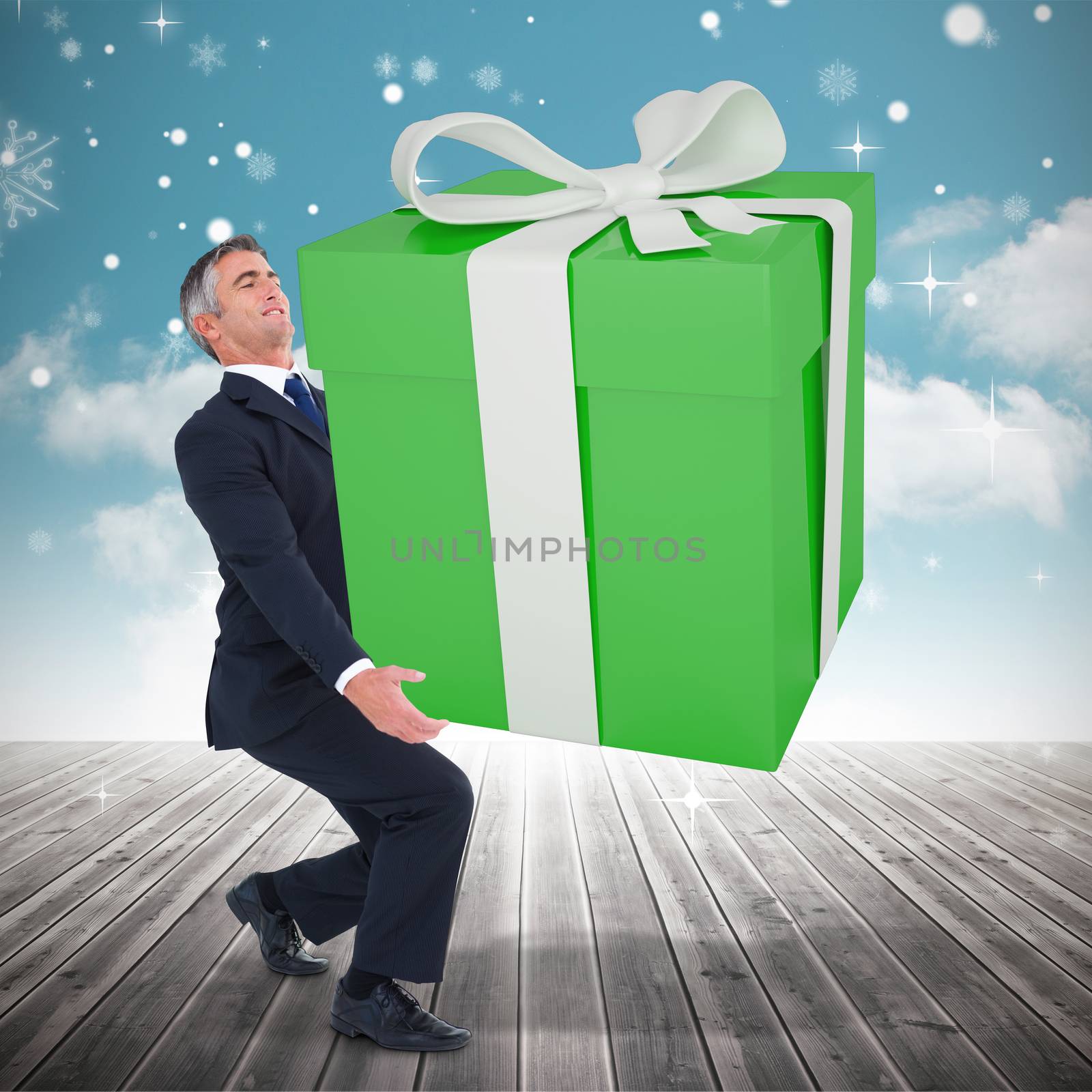 Composite image of stylish man with giant gift by Wavebreakmedia