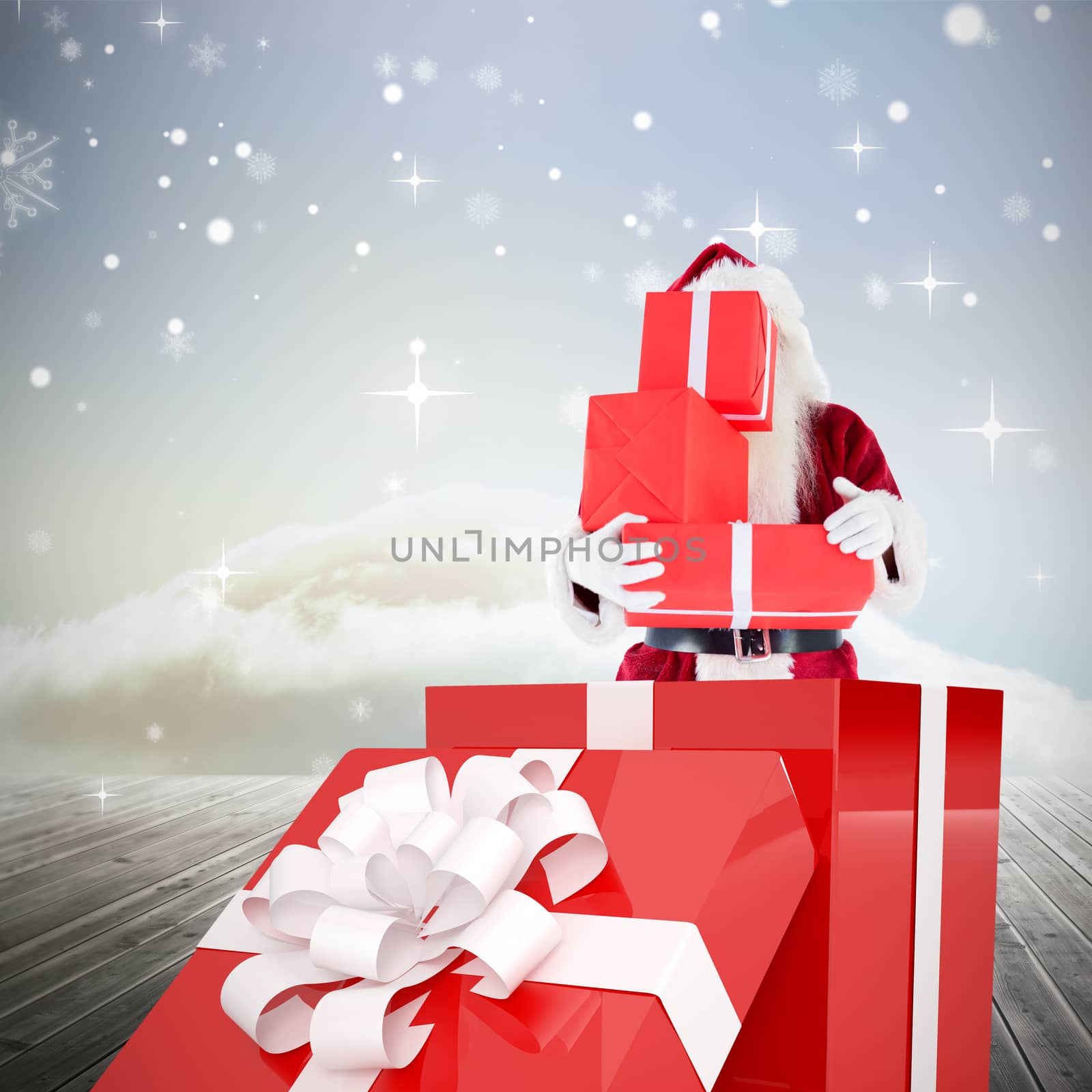 Composite image of santa standing in large gift by Wavebreakmedia