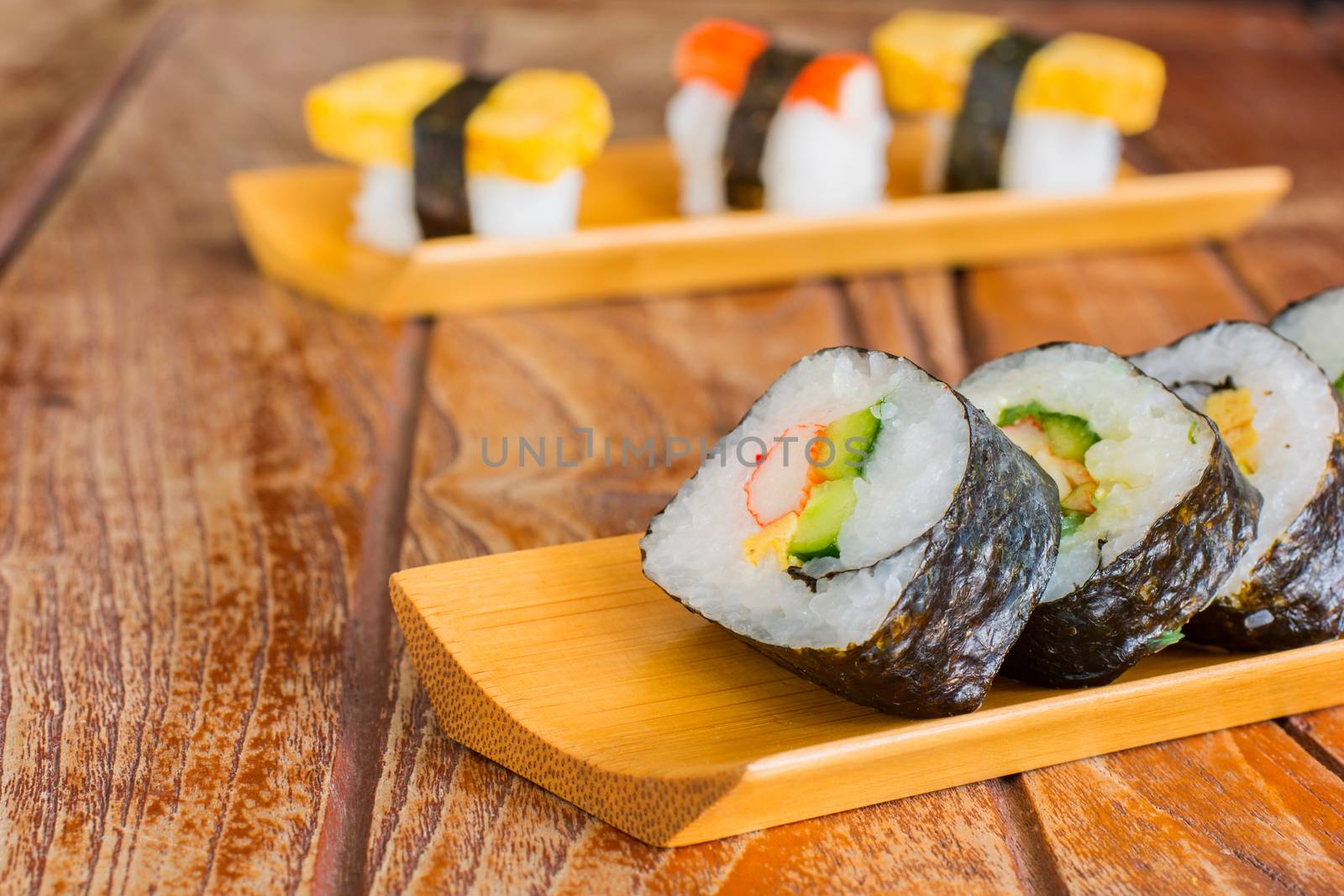 Tamagoyaki maki with seaweed wrap on wooden tray. Delicious japaneses food.