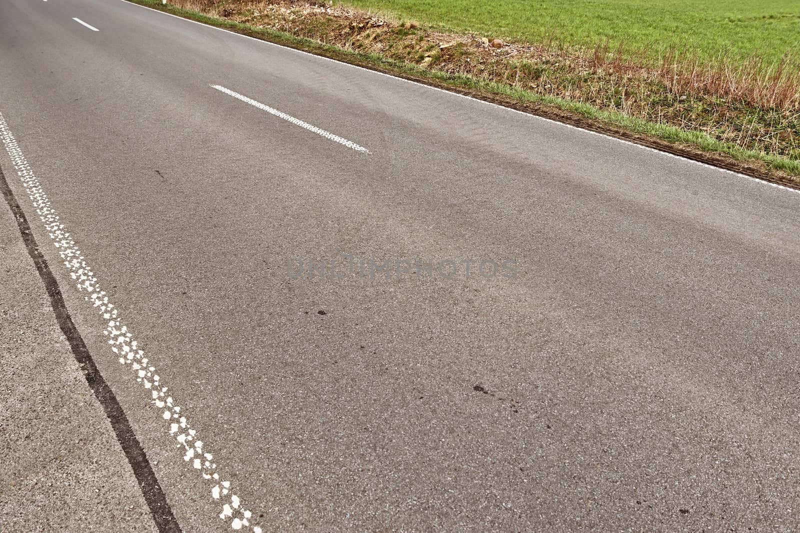 Beautiful view on countryside roads with fields and trees in northern europe.